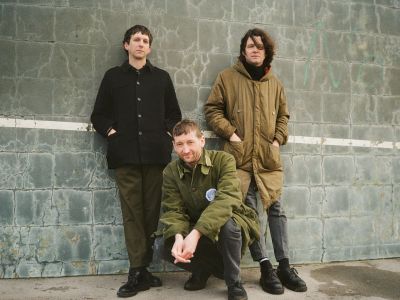 Bad Weed bandphoto. The trio in front of a wall.
